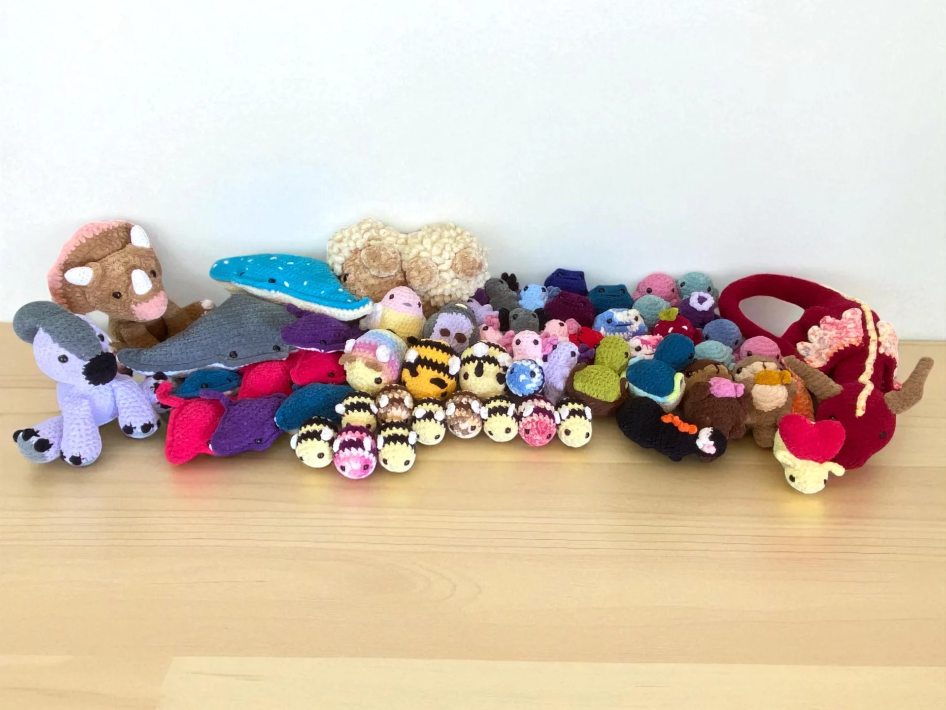 a big group of crocheted plush toys
